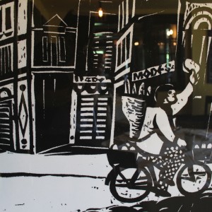 black and white art of man riding on bike with bread
